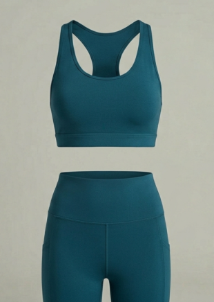 Matching deep teal high-impact sports bra and high-waisted leggings set.