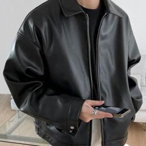 Man wearing a black boxy faux leather jacket with silver zipper and point collar - OH Atelier collection.