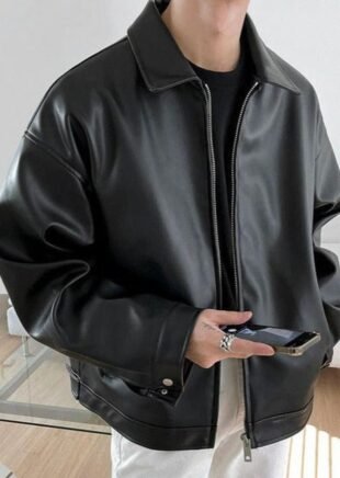 Man wearing a black boxy faux leather jacket with silver zipper and point collar - OH Atelier collection.